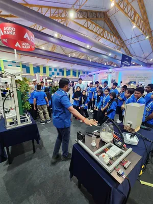 A presenter showing prototypes to a group of students in the AgTech pavilion