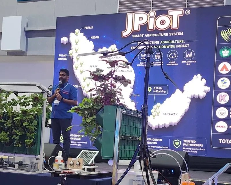 Speaking in front of a JPIoT Smart Agriculture System screen