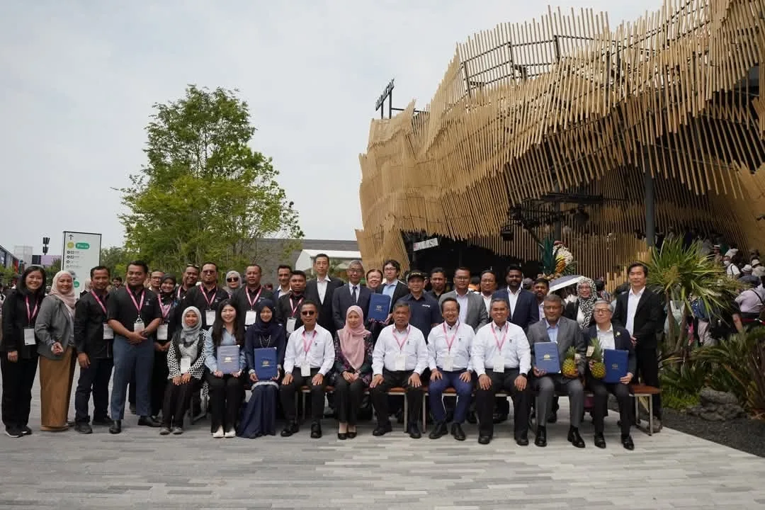 A group photograph in front of the Malaysia Pavilion